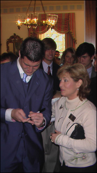 State Representative Michelle Rehwinkel Vasilinda, D-Tallahassee, getting an autograph from University of Florida quarterback Tim Tebow during a visit to the Governor's Mansion: Tallahassee, Florida (2009)