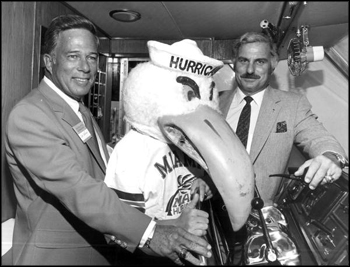 University of Miami head football coach Howard Schnellenberger, right, posing with Don Works and the school mascot for group portrait: Fort Lauderdale, Florida (1981)