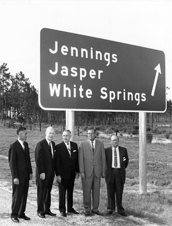 Governor Farris Bryant (second from left) stands with a group of men in front of a large sign along a new section of Interstate 75 in Hamilton County (1964).