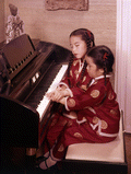 7-year-old Chinese piano prodigy Virginia "Ginny" Tiu with her 5-year-old sister Elizabeth.