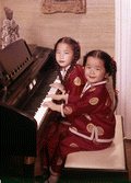 7-year-old Chinese prodigy Virginia "Ginny" Tiu at the piano with her 5-year-old sister Elizabeth.