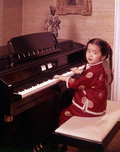 5-year-old Elizabeth Tiu at the piano in the home of artist Ben Stahl.