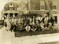 Group portrait of Rotarians in front of the Lake Court Apartments.