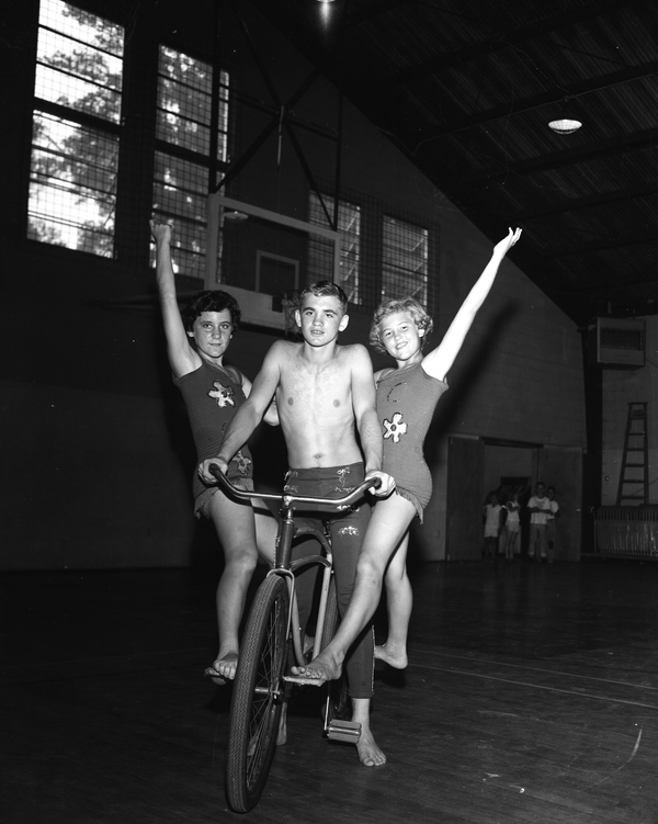 Young circus acrobats practicing on a bicycle in Tallahassee. Terry Folmar, center.