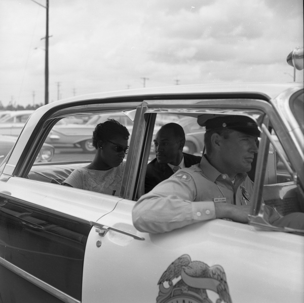 Priscilla Stephens (later Kruize), from CORE, and Reverend Petty D. McKinney, from Nyack, N.Y., in the back of a Tallahassee police car.