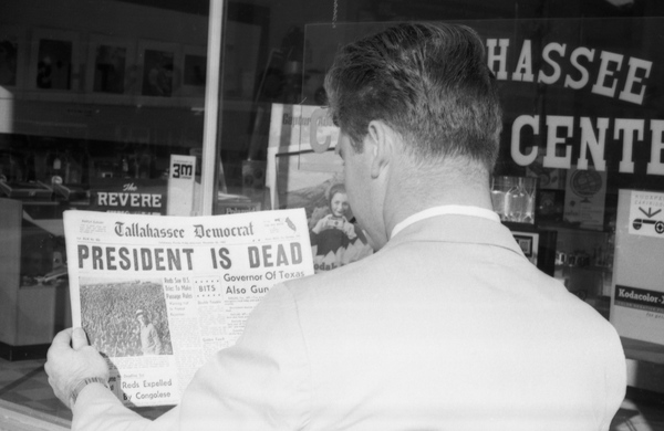 Edsel Dozier reading about President Kennedy assassination in the Tallahassee Democrat newspaper.