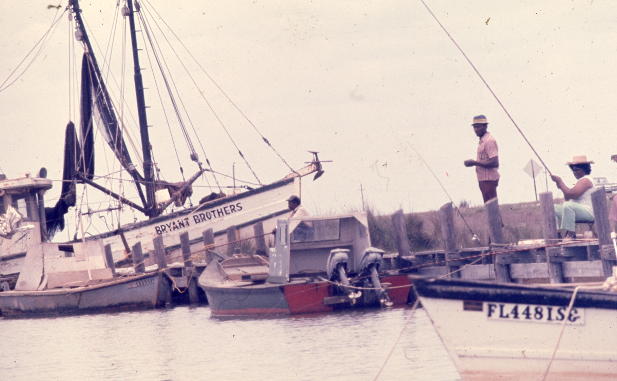African American people fishing from the docks on St. George Island in Franklin County, Florida.