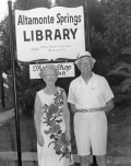 Couple standing in front of the Altamonte Springs Library sign.
