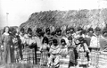 Deaconess Bedell and Seminoles beside a chickee