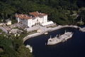 Aerial view overlooking Villa Vizcaya and the stone boat sculpture in Biscayne Bay.