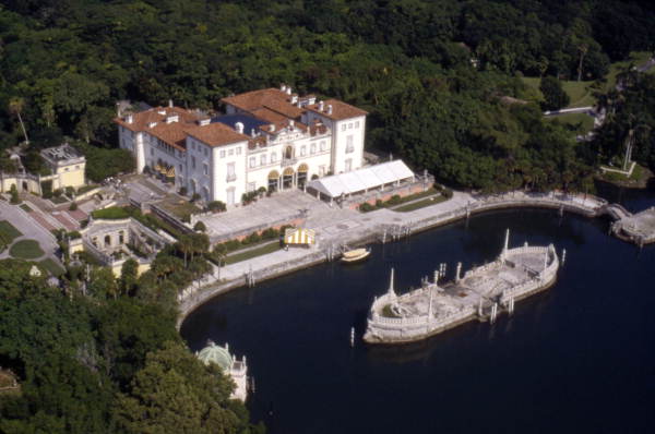 Aerial view overlooking Villa Vizcaya and the stone boat sculpture in Biscayne Bay.
