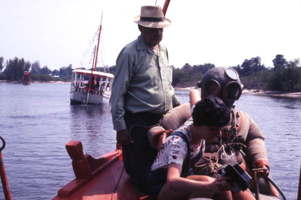 Tourist taking instant photo with sponge diver during diving exhibition in Tarpon Springs, 1975