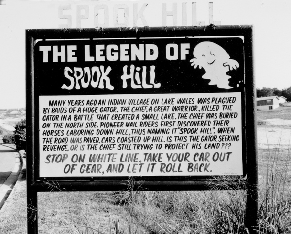 The makers of this sign at Spook Hill in Lake Wales seem to have some doubts about the legend of Sarsparilla and Vanilla (ca. 1950).