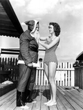 Mary Darlington adjusting "Santa" Newt Perry's beard before he goes underwater at Weeki Wachee Springs amusement park.