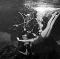 Santa (Newt Perry) gets a big hug from grateful mermaid who has received a brand new pair of paddle fins for Christmas - Weeki Wachee, Florida.