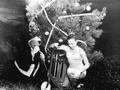 Patsie Boyett presented with scooter by "Santa" Newt Perry ten feet underwater at Weeki Wachee Springs amusement park.