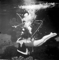Mary Dwight giving "Santa" Newt Perry a hug after receiving a gift underwater at Weeki Wachee Springs.