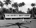 A young girl stands by the passenger car "Rambler" displayed at the Flagler Museum - Palm Beach, Florida.