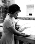 A young girl gazing at a telegram at the Flagler Museum - Palm Beach, Florida.