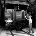 An employee cleaning a steam locomotive displayed at the Gold Coast Railroad Museum - Fort Lauderdale, Florida.