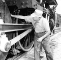 An employee checking a steam locomotive of the Gold Coast Railroad Museum - Fort Lauderdale, Florida