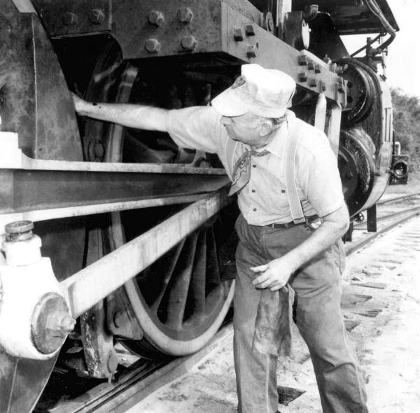 An employee checking a steam locomotive of the Gold Coast Railroad Museum - Fort Lauderdale, Florida