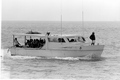 Boat loaded with Cuban refugees arriving in Key West during the Mariel Boatlift.