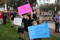 Gun-control activists with their signs at the Old Capitol during the Never Again Rally in Tallahassee.