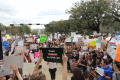 Close-up view showing demonstrators with their signs during the Never Again Rally in Tallahassee.