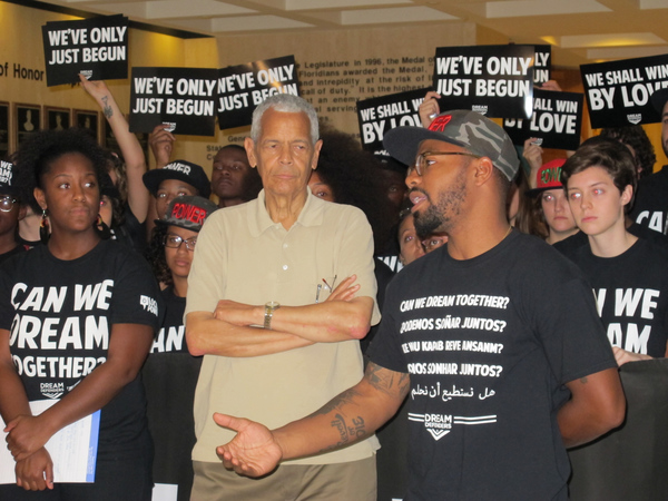 Julian Bond listening with others as Phillip Agnew speaks during rally at the Capitol in Tallahassee.