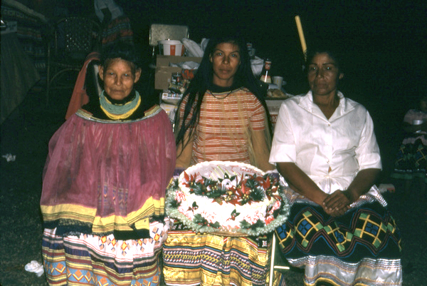 Seminole women with cake during the Christmas feast at Susie Billie's village in Ft. Myers.