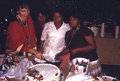 Photographer's wife Gladys helping to cut cake during the Christmas feast at Susie Billie's village in Ft. Myers.