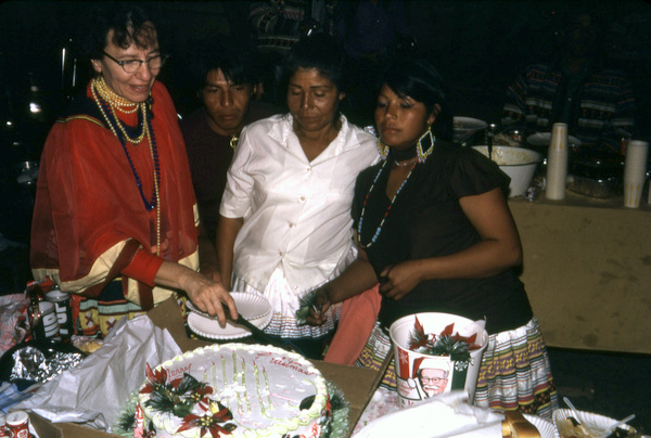 Photographer's wife Gladys helping to cut cake during the Christmas feast at Susie Billie's village in Ft. Myers.