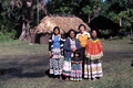 Photographer's wife Gladys posing with Seminole Indians from the Billie family.