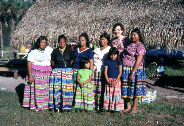 Photographer's wife Gladys posing with Seminole Indians from the Billie family.