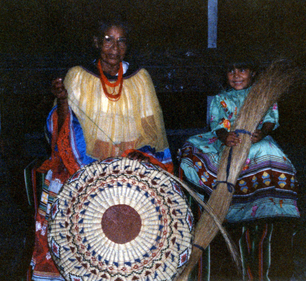 Susie Billie weaving sweetgrass with her granddaughter Ashley.