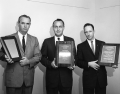 Award winners proudly holding up their plaques in Tallahassee, Florida.