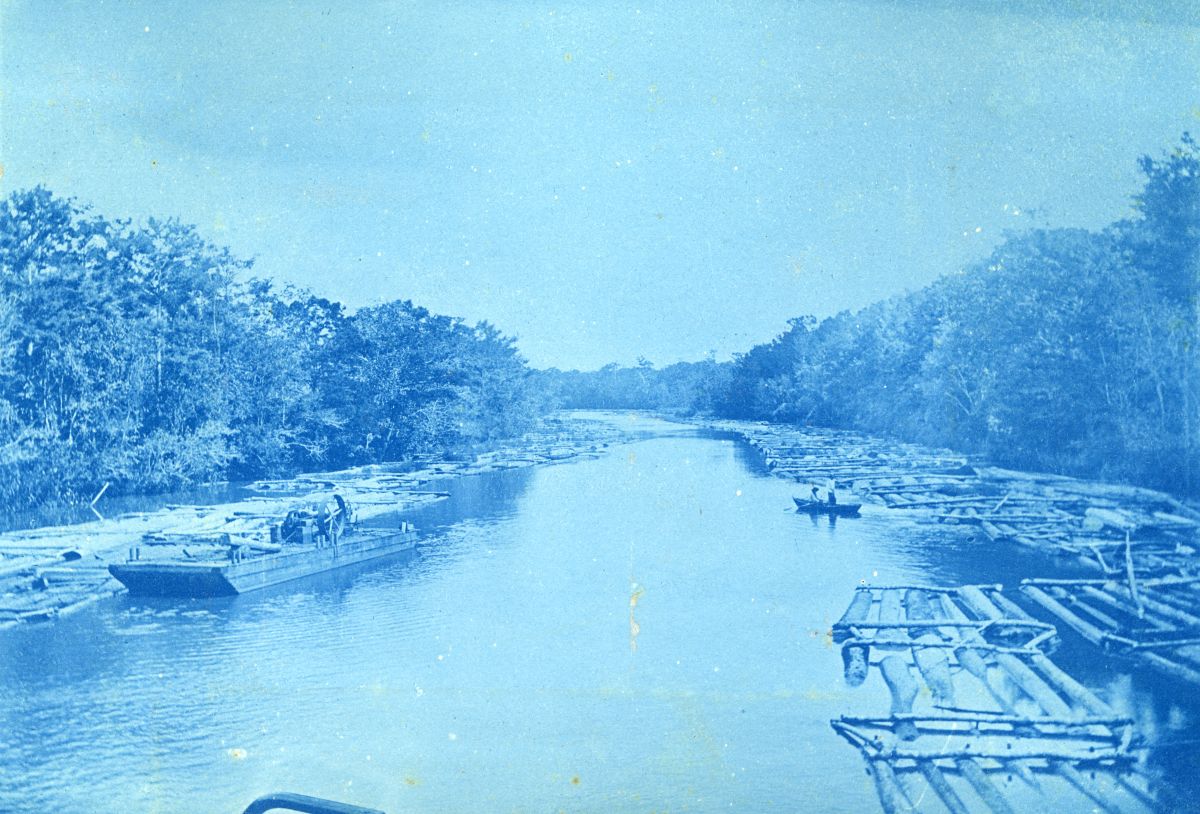 Log rafts being transported along river at Apalachicola, Florida, February 1899