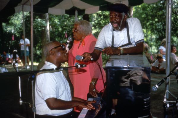 Street crier Tommy Walton performing with Blind Willie James and "Diamond Teeth" Mary McClain at the 1991 Florida Folk Festival.