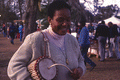 Woman playing a West African talking drum at the Zora Neale Hurston Festival of the Arts and Humanities in Eatonville, Florida.
