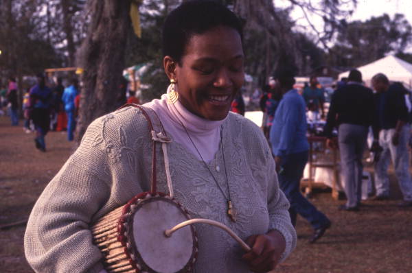 Woman playing a West African talking drum at the Zora Neale Hurston Festival of the Arts and Humanities in Eatonville, Florida.