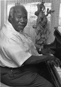 Gospel musician Willie Eason playing the piano in Florida.