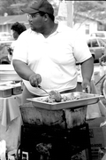 Jamaican American man cooking Jamaican food at Zora Neale Hurston Festival- Eatonville, Florida