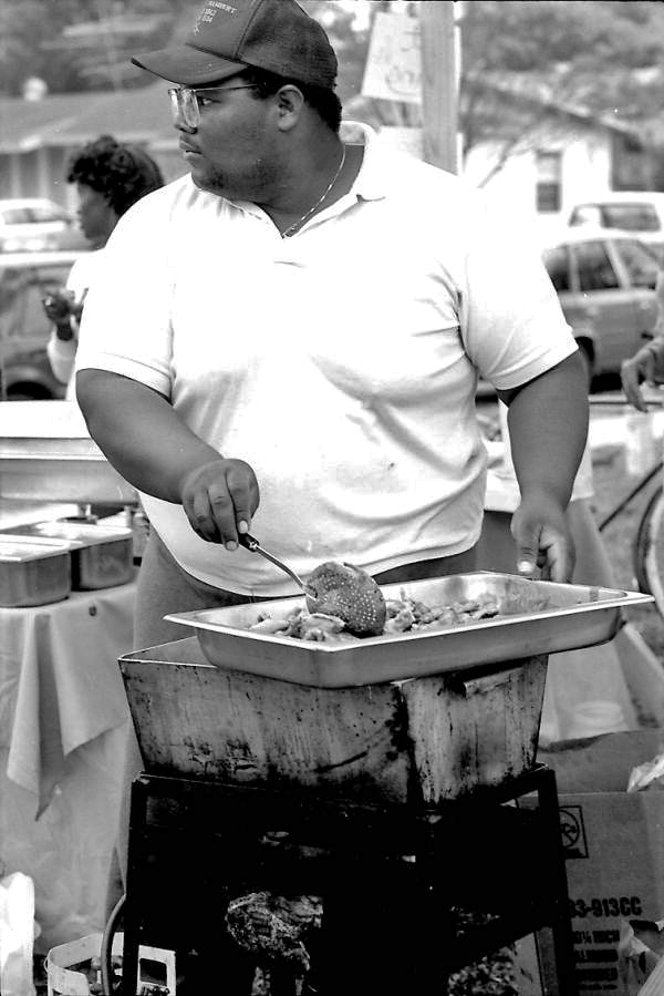 Jamaican American man cooking Jamaican food at Zora Neale Hurston Festival- Eatonville, Florida