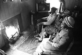 Basket maker Lucreaty Clark and friends sitting around a fire at Clark's house- Lamont, Florida