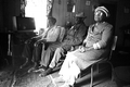 Basket maker Lucreaty Clark and friends sitting around a fire at Clark's house- Lamont, Florida