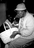 Basket maker Lucreaty Clark holding a white oak basket she made- Lamont, Florida