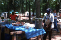 Street crier Tommy Walton getting a drink from water cooler at the Florida Folk Festival - White Springs, Florida.