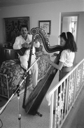 Ana Maria DeArmas playing the Venezuelan harp as Jesus Rodriguez accompanies on cuatro- Naples, Florida