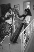 Ana Maria DeArmas playing the Venezuelan harp as Jesus Rodriguez accompanies on cuatro- Naples, Florida